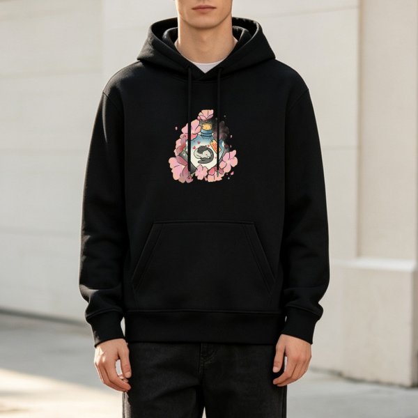 Black hoodie with sleeping cat in potion bottle surrounded by pink cherry blossoms