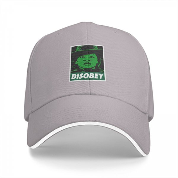 Black baseball cap with green 'DISOBEY' portrait graphic