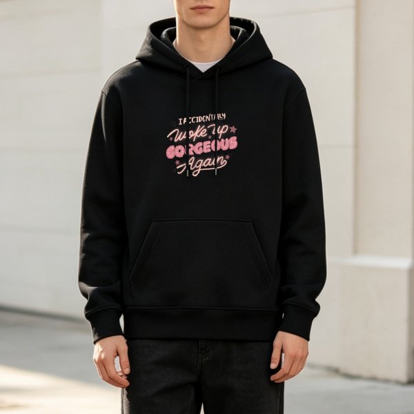 Black hoodie with 'I Accidentally Woke Up Gorgeous Again' pink graphic