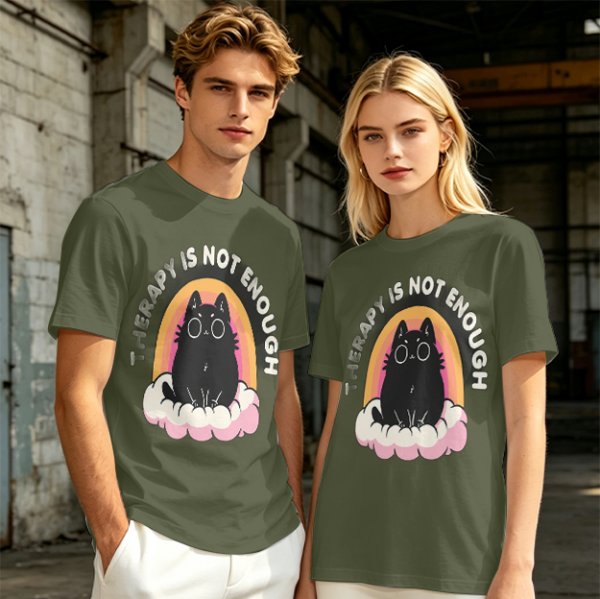 Olive graphic tee with black cat, rainbow, and 'Therapy Is Not Enough' text