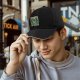 Black baseball cap with 'Don't Trust The Wizard' robot graphic